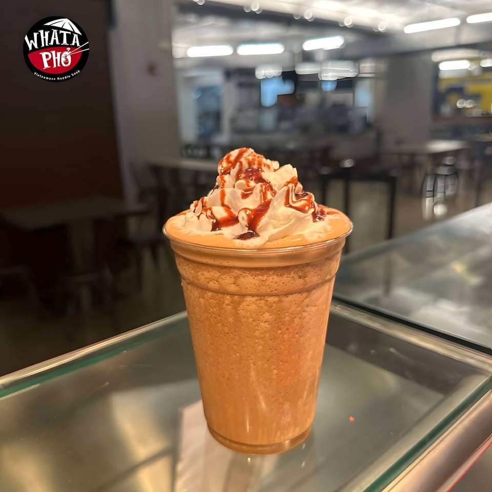 A Whata Pho Vietnamese coffee frappe with whipped cream and chocolate and caramel drizzle.
